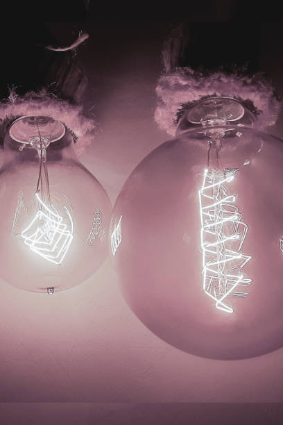 istock Edison light bulbs with a tungsten spiral in a vacuum close-up next to a concrete wall 2149074579