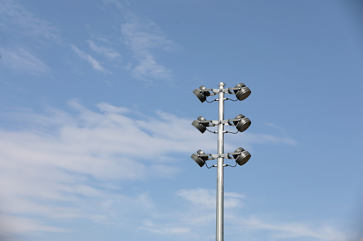 Street light with white cloud on blue sky background