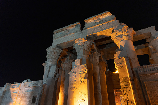Ancient egyptian temple of Kom Ombo on the Nile river bank illuminated at night, Aswan- Egypt