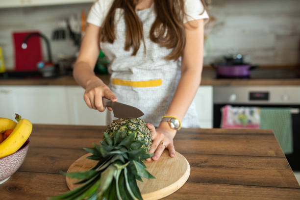 Young woman preparing salad for herself in the kitchen