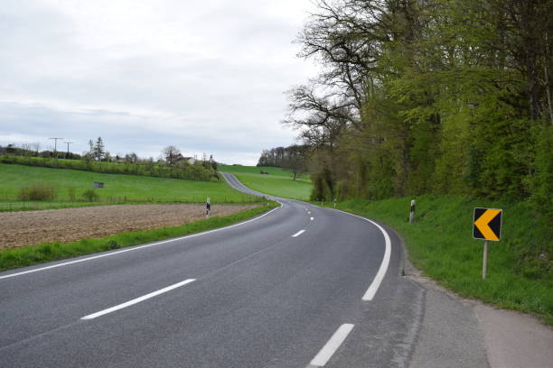 istock country road curve up a hill 2149075478