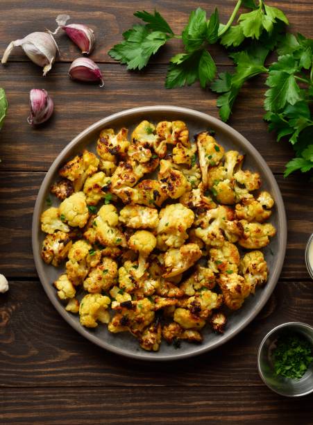 istock Roasted cauliflower on wooden background 2149076100