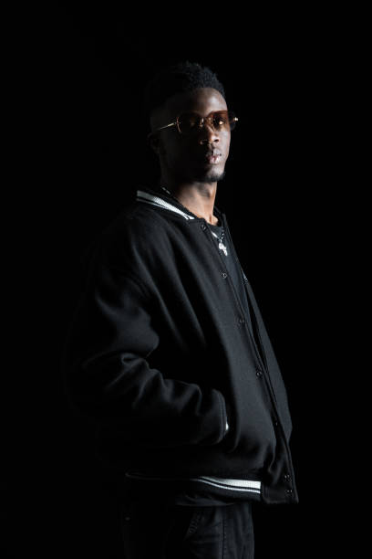 istock Serene expression of a black man in studio portrait with black background 2149076235