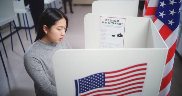 istock Asian woman at US voting booth. 2149076331