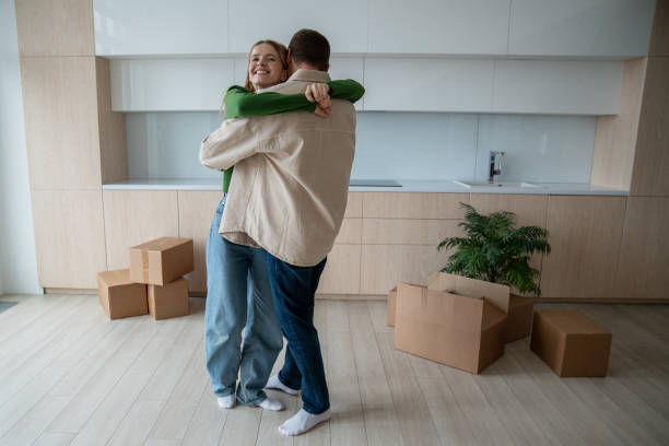 istock Happy married couple hugs affectionately moving into new home with sincere joy excitement in embrace 2149079352