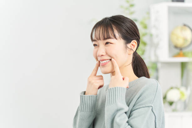 A woman practicing smiling in the living room