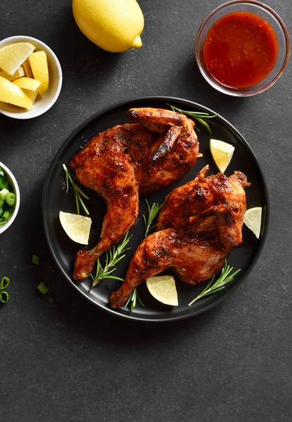 istock Grilled half chicken with lemon and rosemary. Top view, flat lay 2149079955