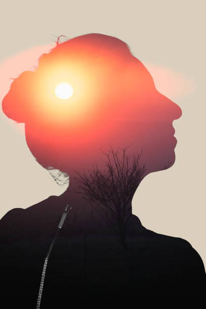 Woman in profile looking upwards on a setting sun background, double exposure energy, relaxation, wellbeing