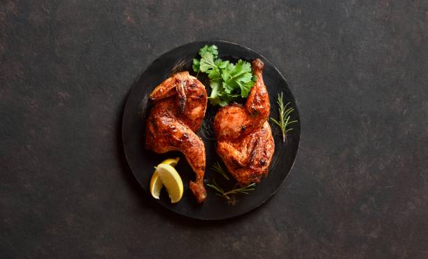 istock Roasted half chicken on black wooden board 2149079968