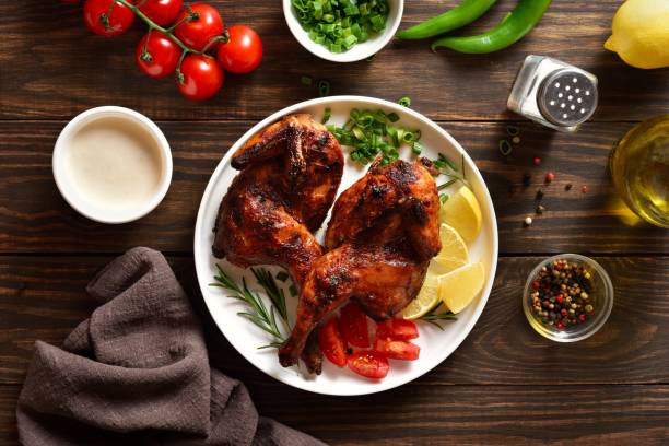 istock Roasted half chicken on white plate over wooden table. Top view, flat lay 2149079991