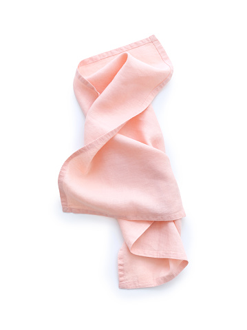 Top view pink linen kitchen napkin isolated on white background. Folded cloth for mockup with text space