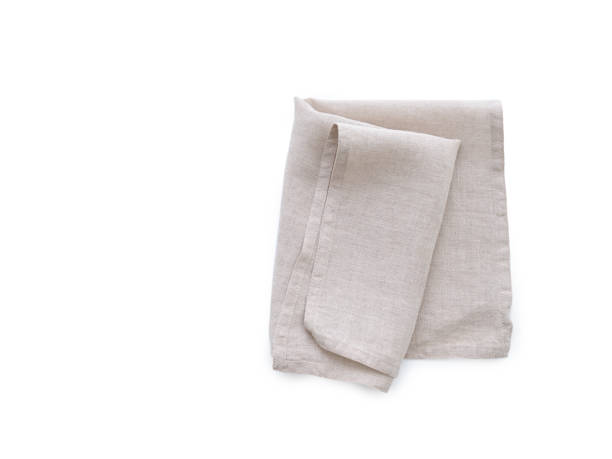 Flat lay with beige linen kitchen napkin isolated on white background. Folded cloth for mockup