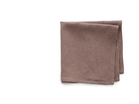 Flat lay with brown linen kitchen napkin isolated on white background. Folded cloth for mockup