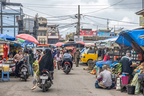 Berastagi, North Sumatra, Indonesia - January 27th 2024:  Traffic with motorcycles at the famous food street market