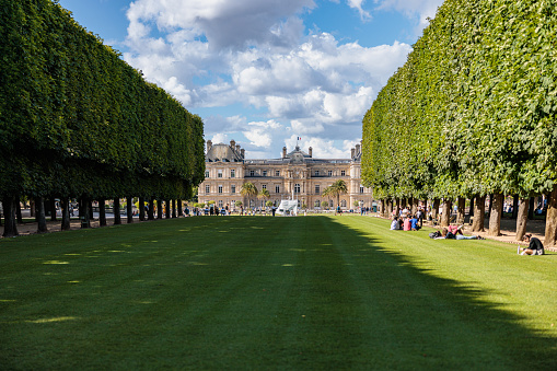 Paris, France - July 6, 2022: View at Luxembourg Museum (Musée du Luxembourg) in the diminishing perspective, beautiful grass and trees in the Luxembourg Gardens