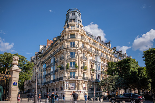 Paris, France - July 6, 2022: View at a corner of residential building, interesting baroque architectural features and style