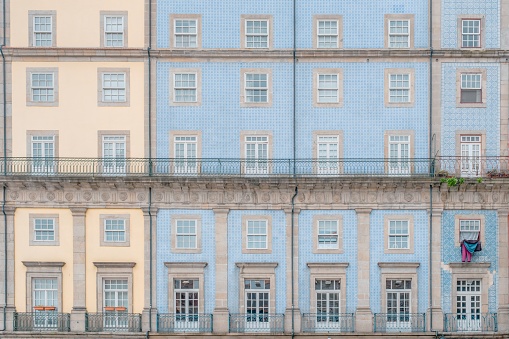 Typical facade of the buildings of the beautiful city of Porto, Portugal. With its typical tiles of Portugal, its windows, balconies and hanging clothes. Next to the Douro river.