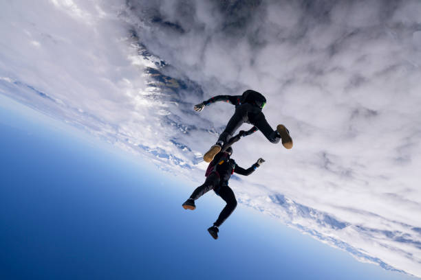 istock Freefall jumpers hold hands mid-air 2149083290
