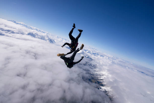 istock Freefall jumpers hold hands mid-air 2149083315