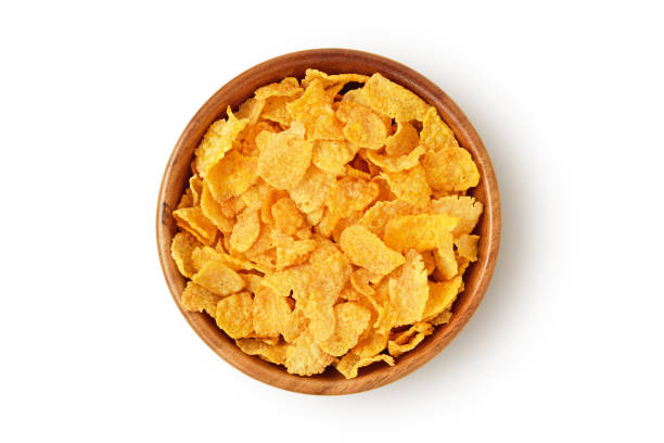 istock Corn flakes in wooden bowl on white background 2149084351