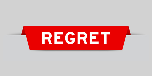 Red color inserted label with word regret on gray background