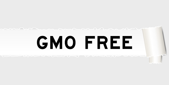 Ripped gray paper background that have word GMO (abbreviation of Genetically Modified Organisms) free under torn part
