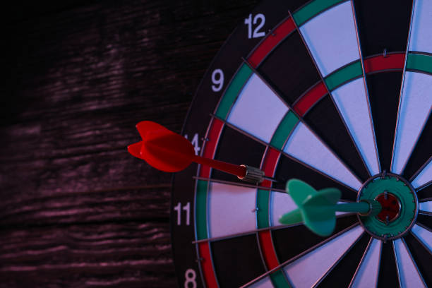 Darts, hitting the target, with wires, on a dark background.
