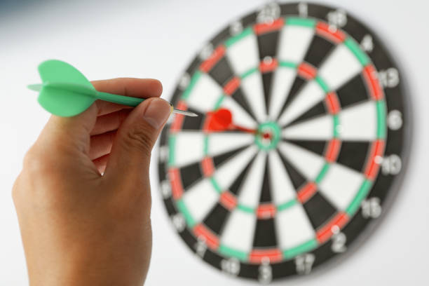 istock Target, dartboard, hitting the center. On a light background, with a wire in his hand. 2149084856
