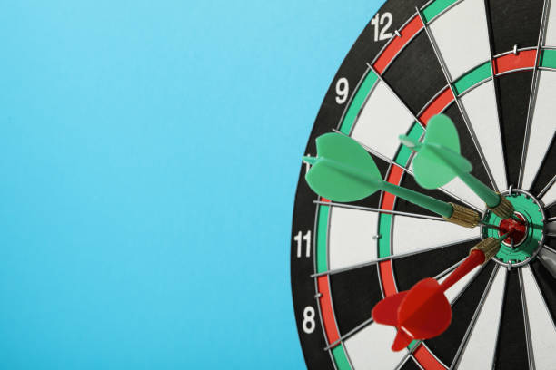 istock Darts hitting the target with wires on a blue background. Close up. 2149084894