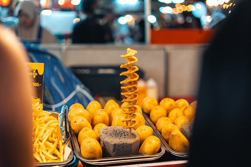 Fried spiralized potato skewers for sale at Street Foodnight Market