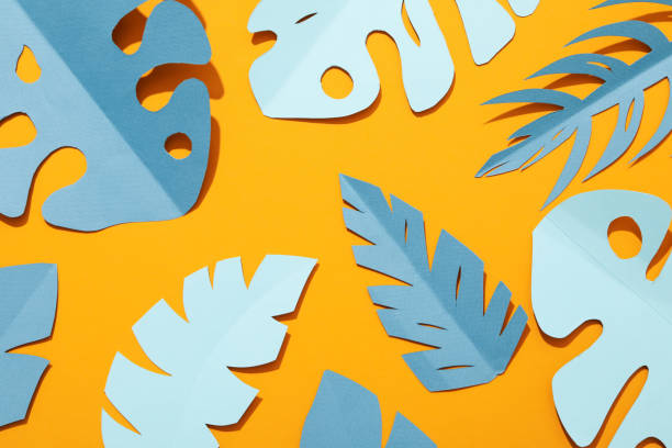istock Paper blue tropical leaves on a yellow background. 2149085625