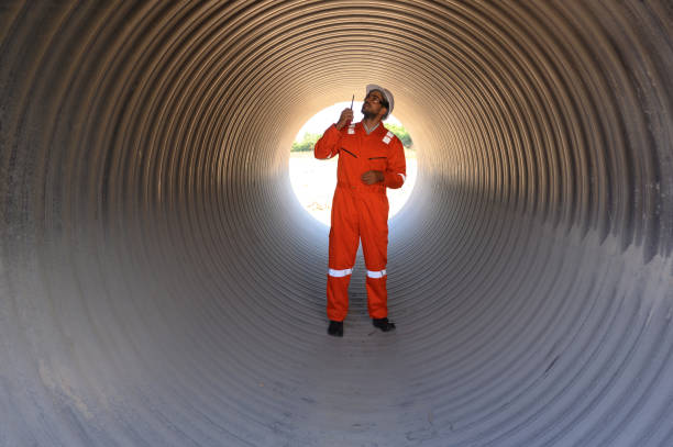 istock Smart engineer with safety suit holding walkie-talkie inspecting large power 2149086853
