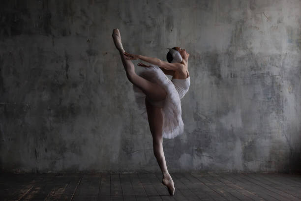 istock Slender ballerina in a white tutu and pointe shoes dances a ballet dance. 2149087302