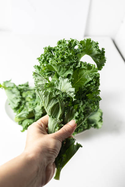 istock A bunch of fresh kale leaves on a white background. 2149087935