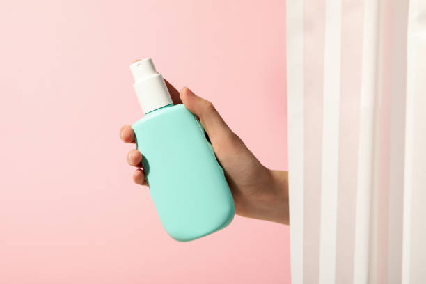 istock Shampoo bottle in hand in pink bathroom 2149088317