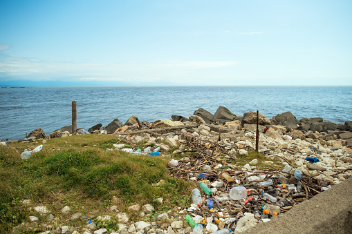 Garbage on the beach, plastic pollution and ecological problems concept