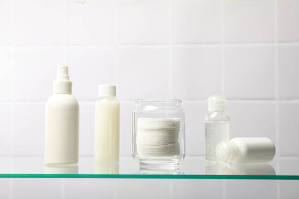 Cotton pads in a jar on the bathroom shelf.