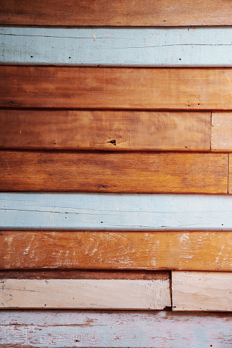 weathered wood wall painted in blue and white