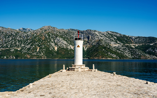 Scenic ancient lighthouse in Montenegro on island. Religion heritage architecture in Kotor bay and Adriatic sea