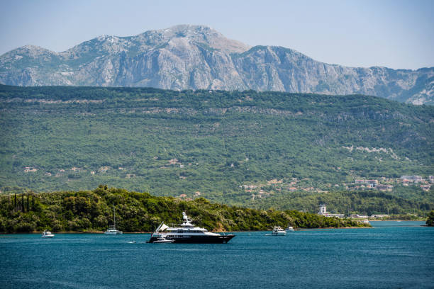 Luxury yacht in Adriatic sea, Montenegro. Touristic boat with view on scenic mountains and forest