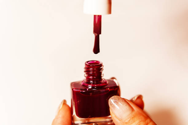 istock Woman's hand opens a bottle of nail polish, 2149090392