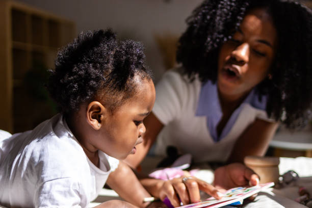 istock Mother and child reading together at home 2149091773