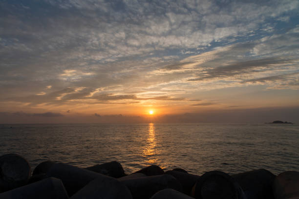 with the clouds on the seawall