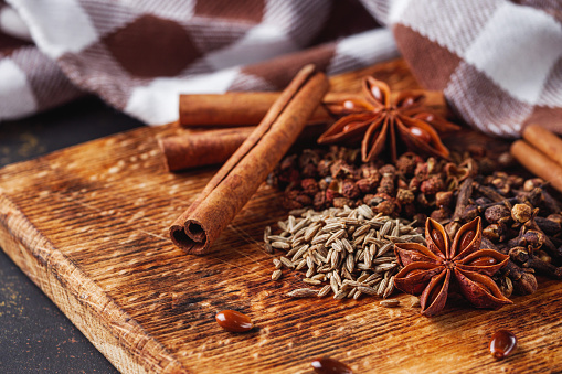 aromatic Chinese five spices on a dark rustic background.