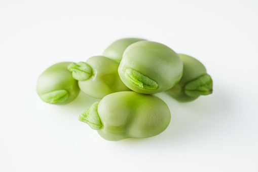 fresh greens broad beans fava on a white background.
