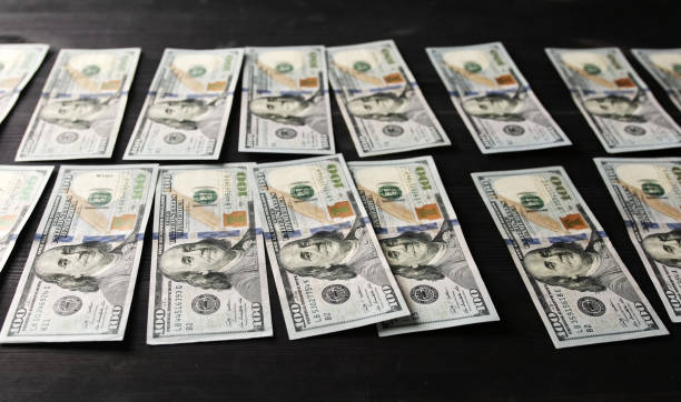 istock One Hundred USA Dollars Laid In Rows On A Table 2149092905