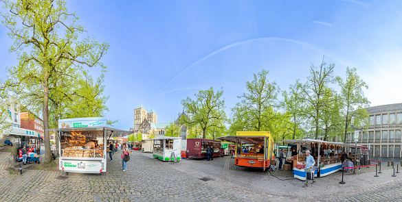 Münster, Germany - April 13, 2024<. farmers market at the cathedral square in Münster with the cathedral in background.