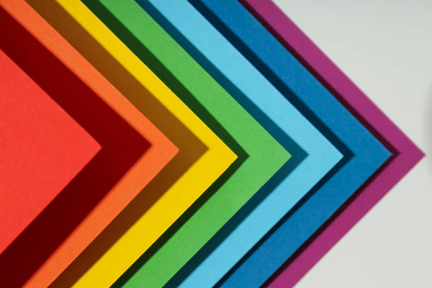 Extreme macro of multicolor background from different colors papers. Abstract colorful vibrant paper textures. Selective focus, shallow depth of field.