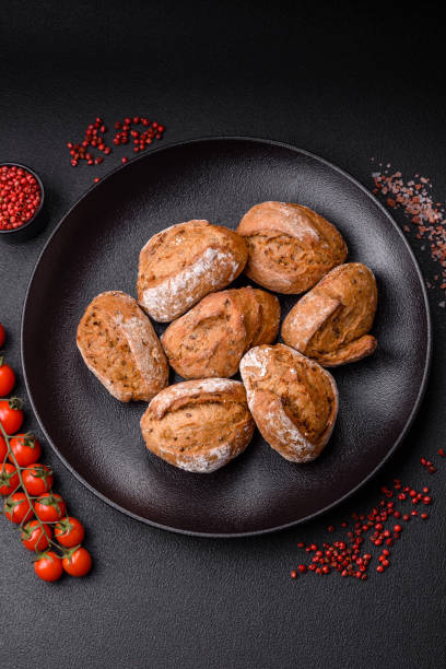 istock Fresh baked bread buns with salt, spices, seeds and grains 2149094125