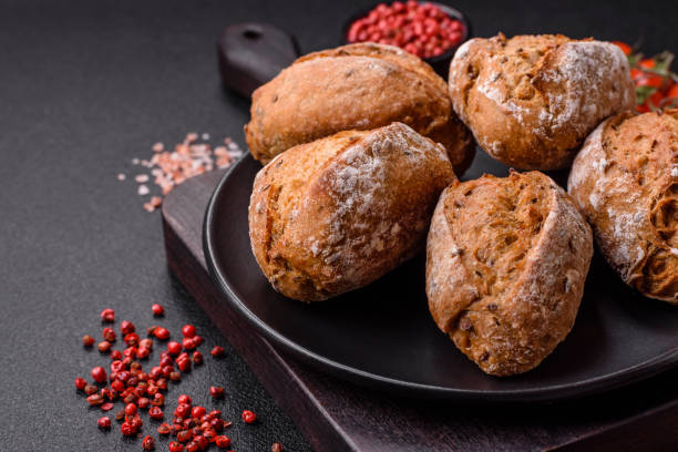 istock Fresh baked bread buns with salt, spices, seeds and grains 2149094189